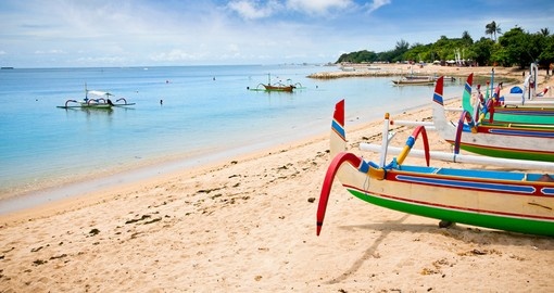 Walk along the beach in Bali where you have the opportunity to rent a traditional fishing boat to explore the ocean on your Bali Vacation