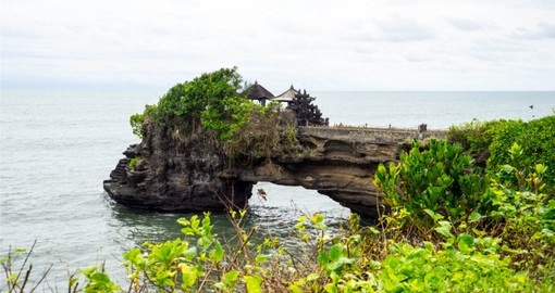 On your Bali Tour, visit the Uluwatu Temple that is situated on a rocky outpost that extends into the ocean
