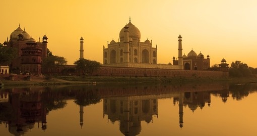 Taj Mahal at sunset reflected in the calm Yamuna River