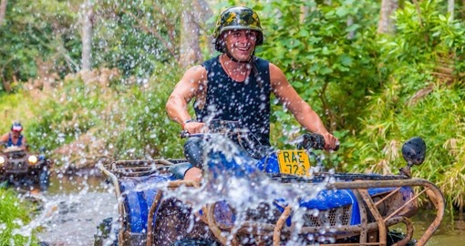 Ride a 4 wheel quad through the streams and wild island jungle during your Cook Islands vacation.