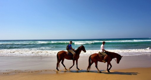 Two horse riders on beach in Sodwana Bay Nature Reserve