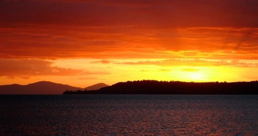Experience Red sunset over Lake Taupo during your next New Zealand tours.