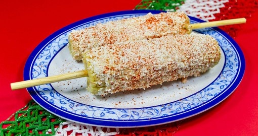 Elote is grilled corn with cheese, lime juice, chili, and butter