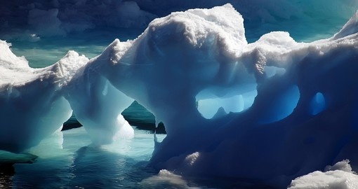 Exploring massive Ice Caves in the icy cold waters of Antarctica on your Antarctic Vacation Package