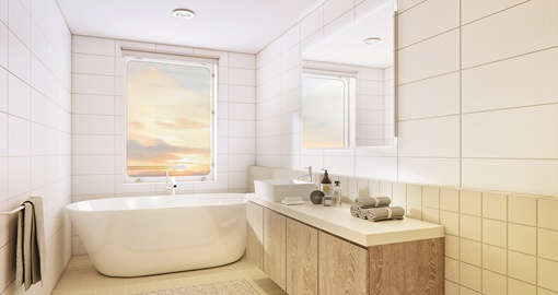 A unique outside-facing bathroom with picture windows, bath and separate shower complete the suite experience