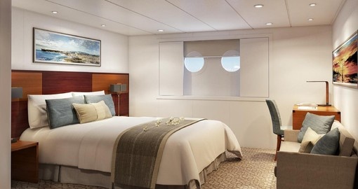 Feature twin portholes for expansive ocean views, along with a desk, sofa, telephone and your choice of Junior King or twin bedding.