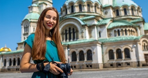 A young women standing near St. Alexander Nevsky Cathedral - one of the most popular sites on all Bulgaria vacations.
