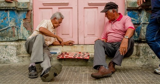 Men playing checkers on the main square of Santa Ana