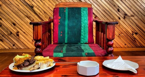 Armchair and table with food in restaurant in Sodwana Bay campsite