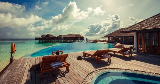Relax and have a drink at the Aqua Bar on the Lily Beach Resort during your Trips to Maldives.