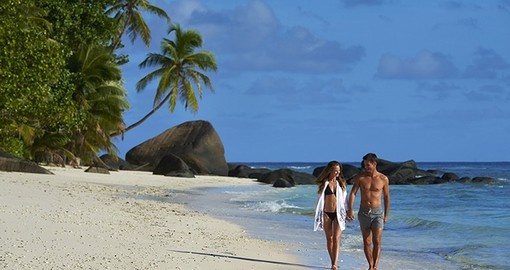 Enjoy a romantic stroll along the beach during your trip to Seychelles.