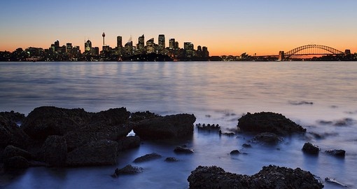 A view across the harbour at sunset is always a popular inclusion on all Sydney tours.