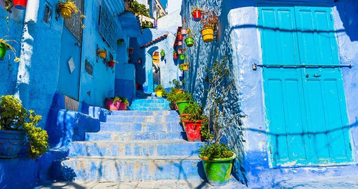 Walk the streets of Chefchaouen, known for its blue-washed walls, weaving, and leather work