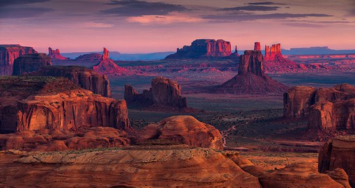 Admire the power of natural formations as you hike to Hunts Mesa through Monument Valley