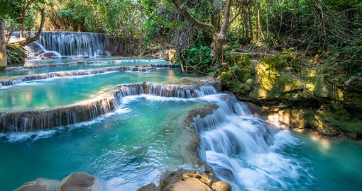 Go for a dip in the Kuang Si Falls, known for their brilliant turquoise shade