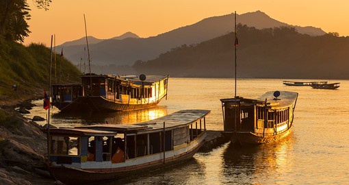 Cruise along the Mekong River to reach Luang Prabang and visit endless monasteries and Buddhist temples