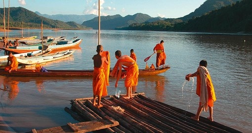 Observe Monks working on the Mekong River during your Laos vacation