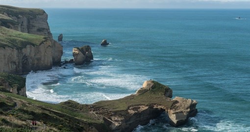 See beautiful Tunnel Beach on the Otago Peninsula during your New Zealand Vacation