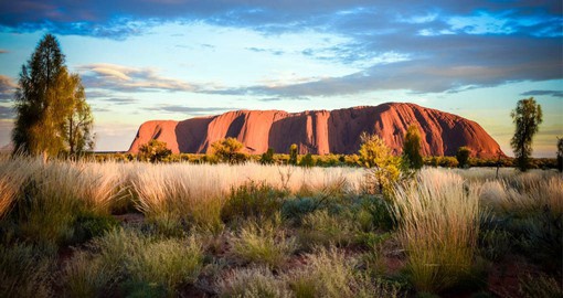 Experience the beauty of Uluru at dusk during your next Australia vacations.