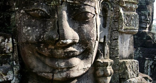 Observe the enigmatic stone faces of Bayon temple on your trip to Cambodia
