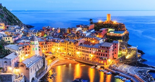 Experience twilight view of Vernazza village on your next Italy vacations.