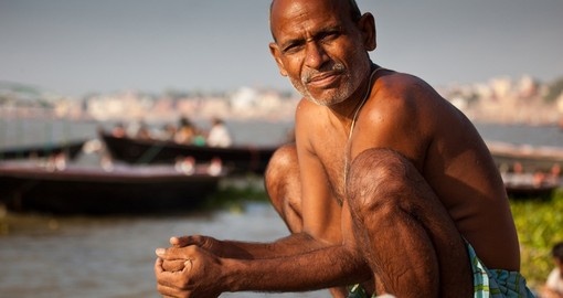 Man bathe at the edge of the Ganges
