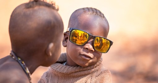 Himba child poses with sunglasses