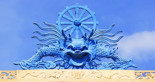 A dragon sculpture on the roof of a Buddhist temple