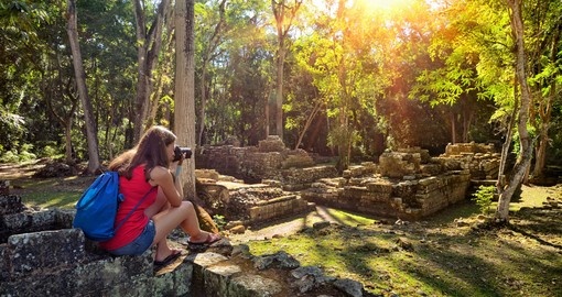 Woman photographing ancient Mayan ruins in Copan