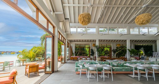 Enjoy a meal with open views of the pool and ocean
